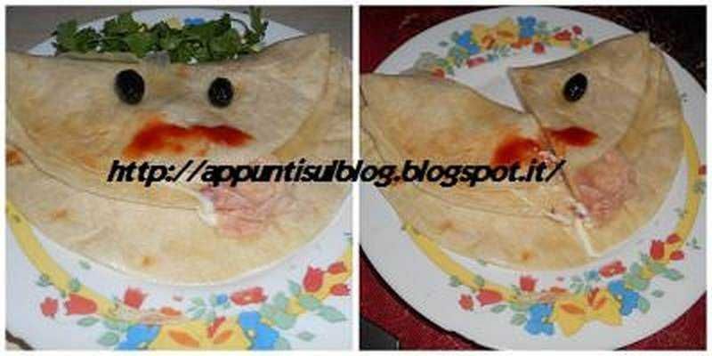 Fantasiosa creazione di piatti con pane e ingredienti per bambini, decorata con occhi e bocca per un aspetto divertente e originale. Ideale per pranzi ludici e creativi con i più piccini.