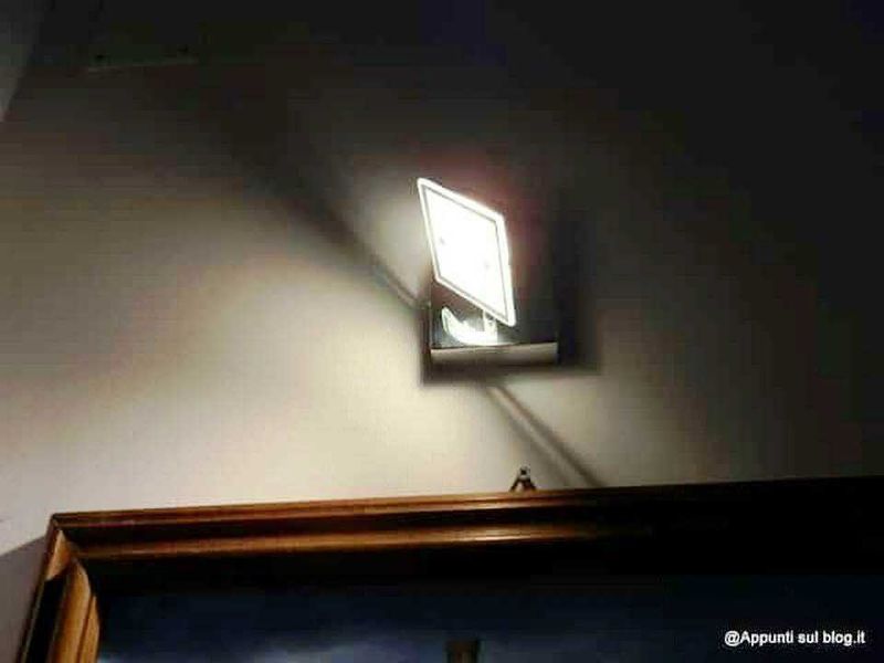Lampada che proietta ombra di segnale di stop sulla parete in una stanza luminosa.
