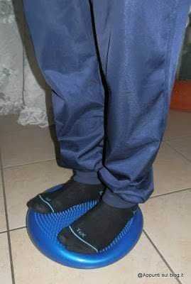 Scarpe sportive padded su balance board per allenamento equilibrio e stabilità, stile casual e outdoor, scarpe tecniche per attività sportive e fitness.