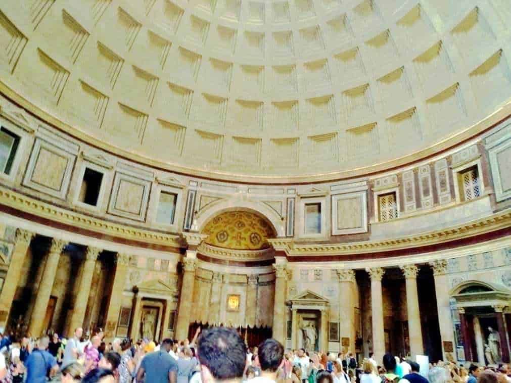 Grand Tour of the Pantheon, interior view showing the massive coffered dome and ancient columns, filled with tourists exploring one of Rome's iconic architectural marvels.