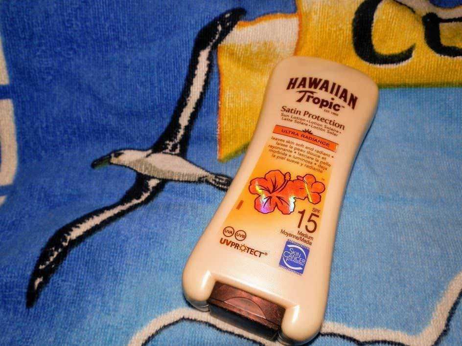 Hawaiian Tropic protezione solare SPF 15 su asciugamano con uccello, ideale per proteggere la pelle dai raggi UV durante l'esposizione al sole.