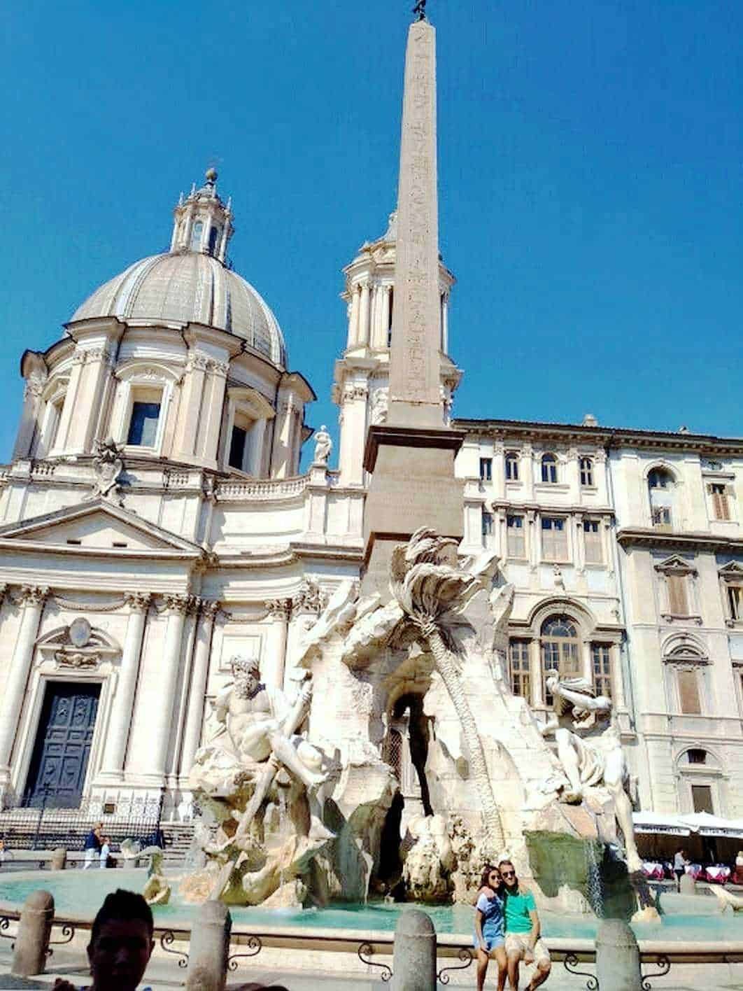 Fountain of the Four Rivers in Piazza Navona, Rome, Italy, featuring majestic baroque sculptures and the ancient Egyptian Obelisk of Domitian, set against the backdrop of the Church of Sant'Agnese in Agone.