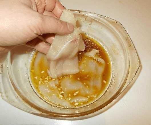 Purè di acqua e amido di mais in una ciotola trasparente, utilizzato come ingrediente in cucina, con un cucchiaio di mano che mescola l'impasto.