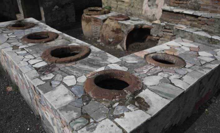 Caldaia antica in pietra e mattoni per produzione di calore, oggetto storico di architettura rustica italiana.