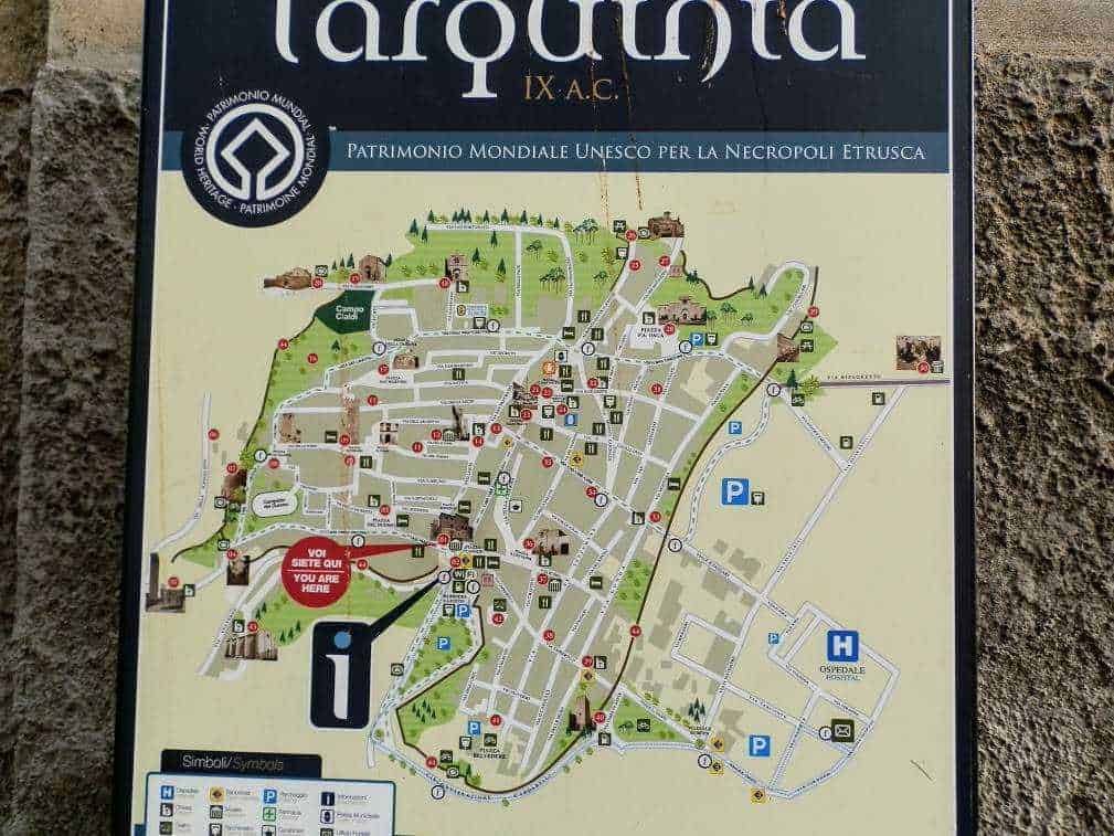 Tavola informativa del sito archeologico di Tarquina, patrimonio mondiale UNESCO a Necropoli Etrusca, con mappa dettagliata dei punti di interesse, parcheggi e strutture sanitarie.