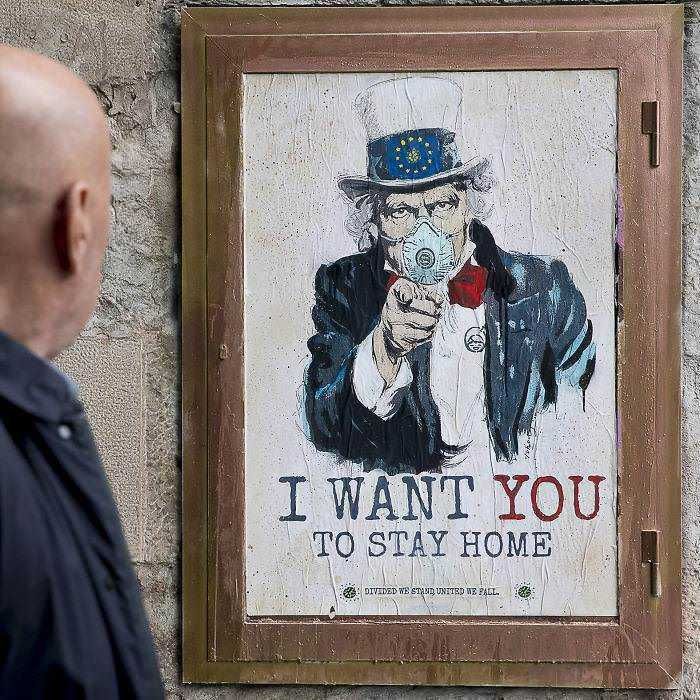 Ventilator di anarchia con raffigurazione di Uncle Sam che indossa una mascherina e punta un’arma diretta verso l'osservatore, con testo "I WANT YOU TO STAY HOME" per sensibilizzare sulle restrizioni durante l'emergenza.