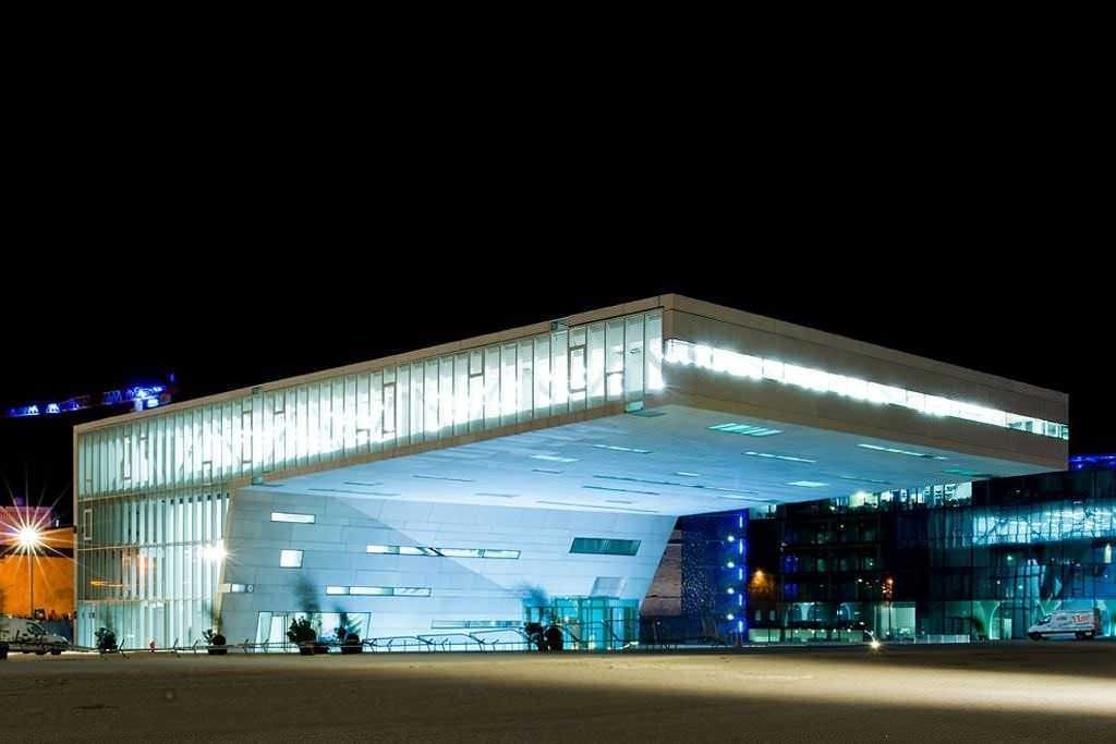 Modern building design with illuminated glass facade featuring innovative architecture.