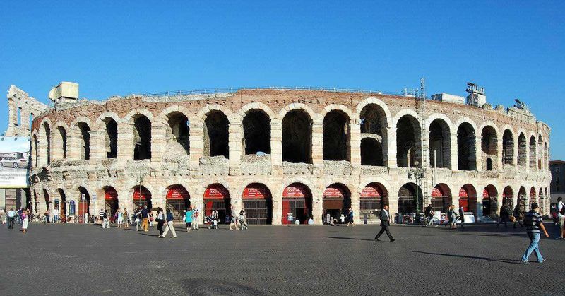 Dove si trova Verona, Meteo e cosa vedere nella Piccola Roma (2026) 6 Colosseo di Roma, anfiteatro romano storico e simbolo dell'antica città, con visitatori che passeggiano davanti all'iconico monumento sotto un cielo azzurro.