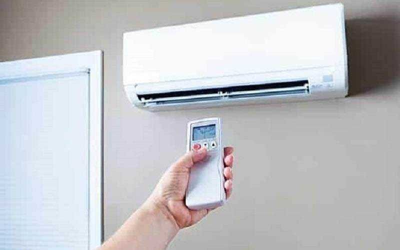 Condizionatore in estate: Climatizzatore split con telecomando in ambiente domestico, controllo della temperatura e comfort estivo.
