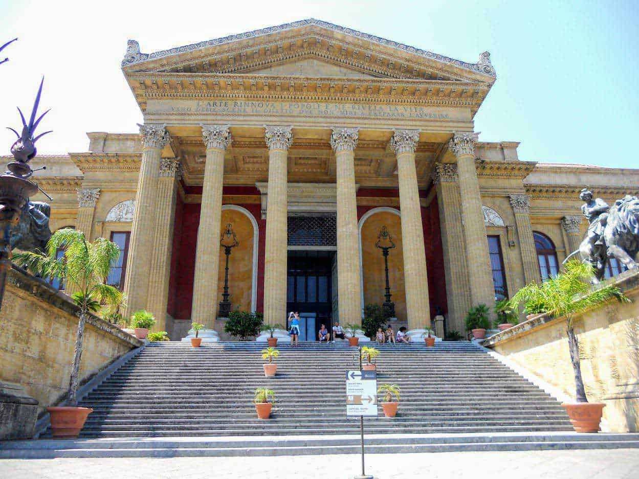 Front view of a historic classical building with grand staircase, tall columns, and intricate architectural details, ideal for exploring cultural heritage, architecture, and history.