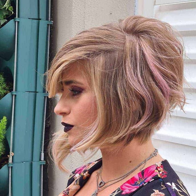 8 Tagli di capelli donna che ringiovaniscono per donne over 60 11 Cabello corto sbarazzino con tonalità biondo cenere e sfumature rosa, acconciatura moderna e di tendenza.