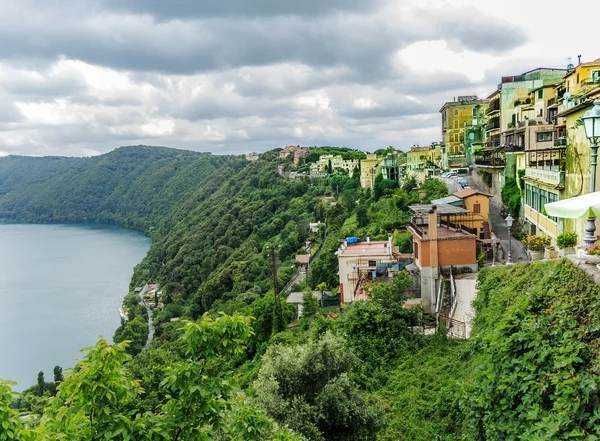 Colorful hillside houses with laundry hanging outside, narrow stairways, and charming windows in an Italian village. A picturesque scene showcasing Mediterranean architecture and vibrant local life.
