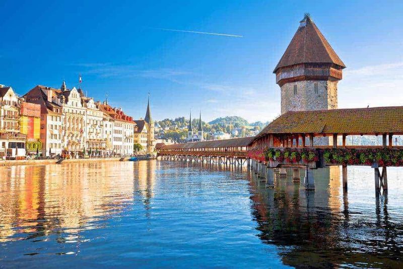 Luzern wooden Chapel Bridge and tower panoramic view, landmark in town in central Switzerland