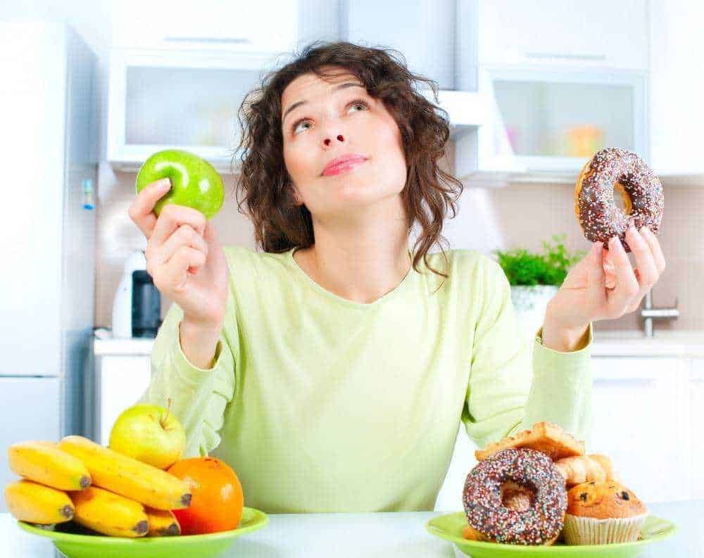 Mangiare sano e dolci, donna con frutta e dolci, dieta equilibrata e alimentazione sana,AppuntiSulBlog, alimentazione corretta, stile di vita sano, scelta alimentare consapevole.
