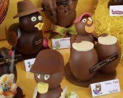 Fabbricati di cioccolato e marzapane a forma di personaggi, con dettagli realistici e colorati, perfetti per decorazioni di dolci e regalini, esposti come decorazioni artigianali.