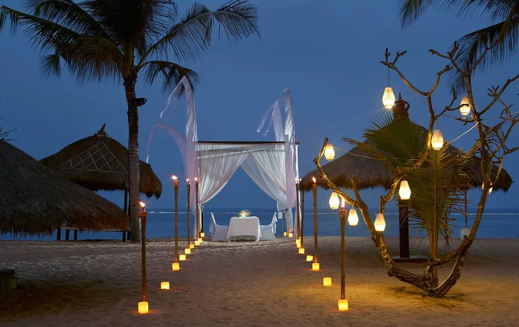 private table on beach at night with lighted path