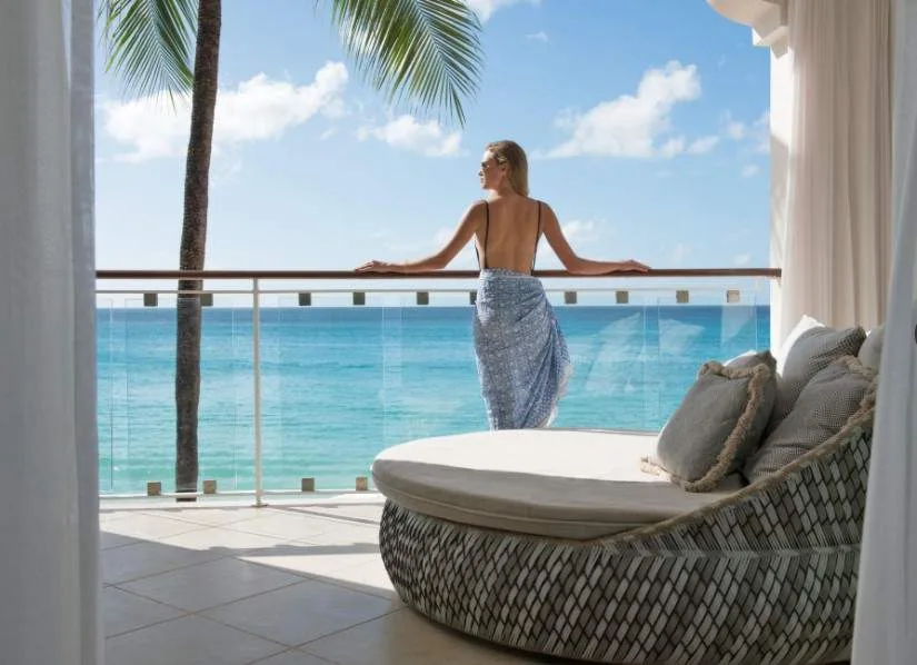 woman on balcony overlooking ocean