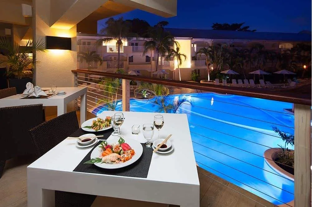 table with food in front of pool