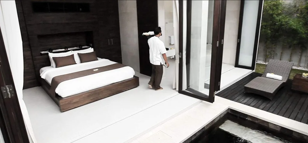 man standing in front of bed