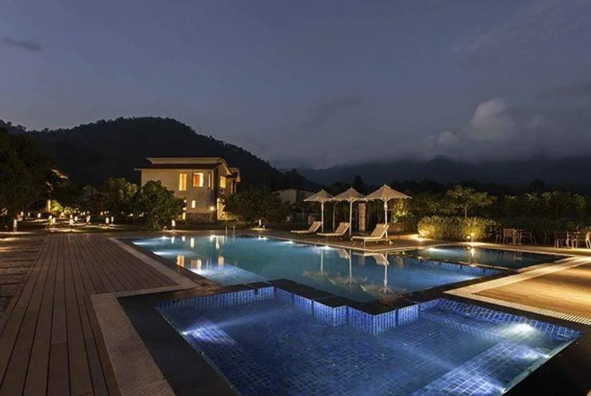 lighted pool at night in front of mountain