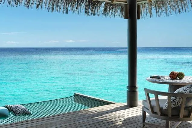 pool under umbrella overlooking ocean