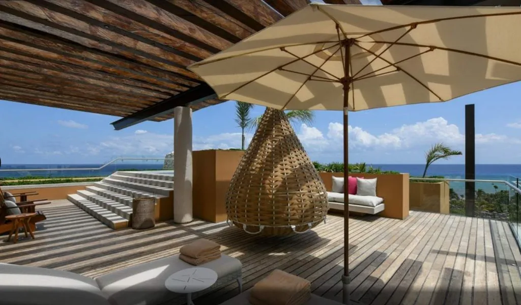 table with umbrella under covered deck