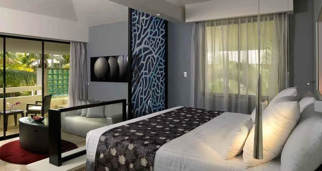 white bed in room with white couch