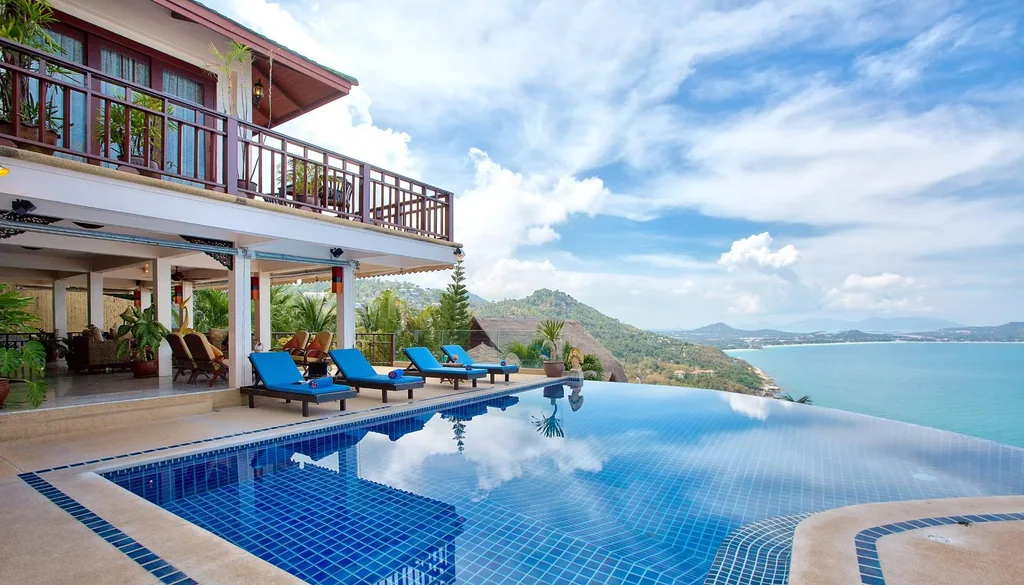 infinity pool surrounded by blue folding chairs