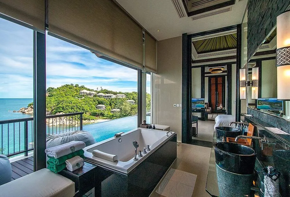 resort room with bathtub overlooking ocean