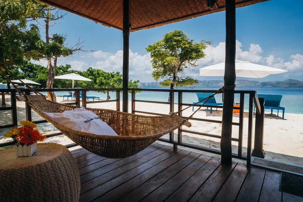 hammock under covered patio on white sand beach