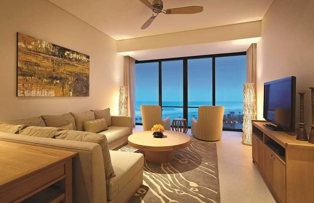 resort room with round table in front of large windows