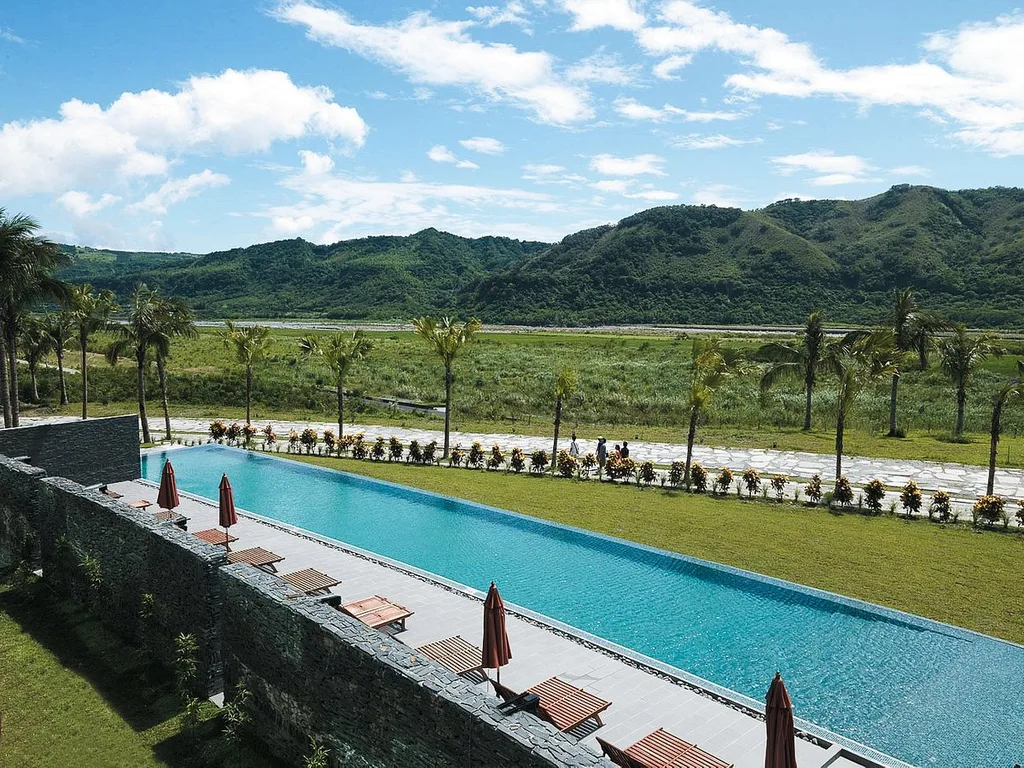 long resort pool with mountains in background