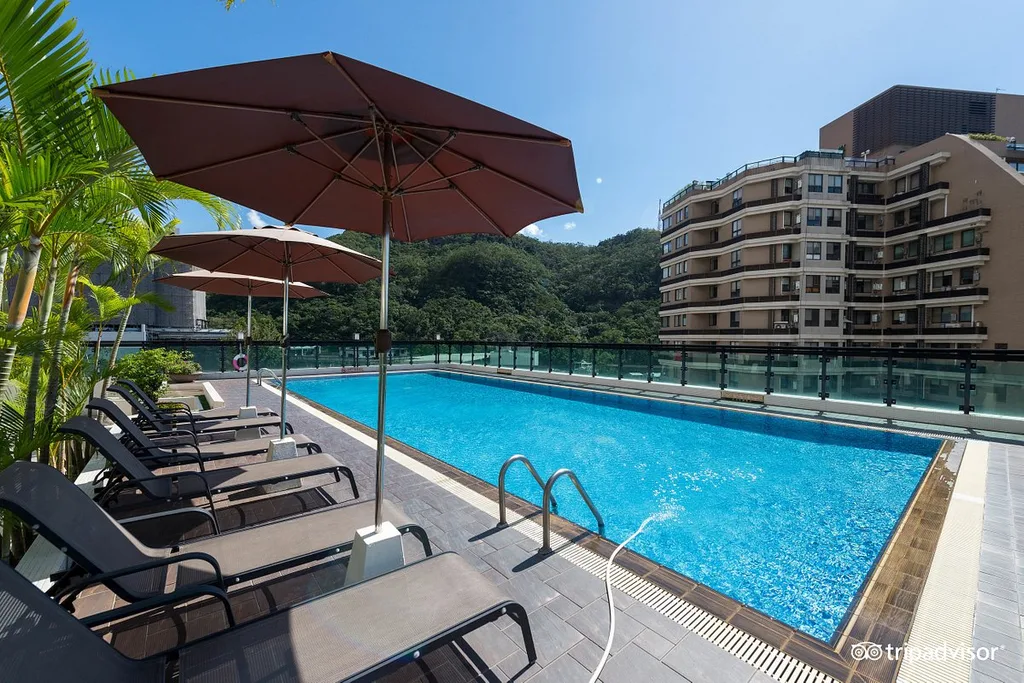 long resort pool with umbrella and lounge chairs