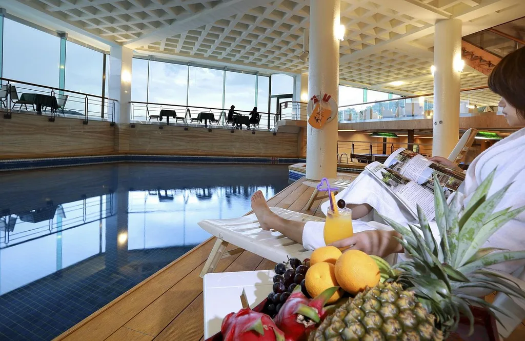 indoor pool with woman sitting next to fruit