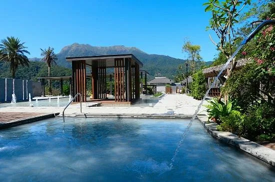 large square resort pool with mountains in background