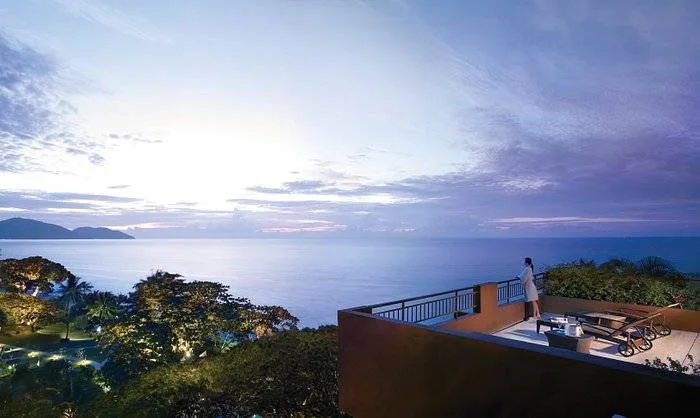 private balcony overlooking water at dusk