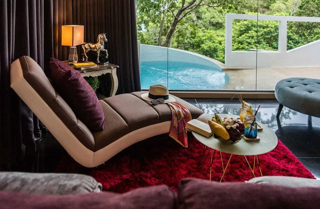 contoured chair in resort room with pool on other side