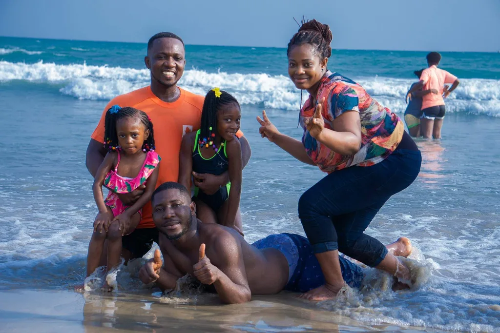 parents with two young children and a teenage boy on beach