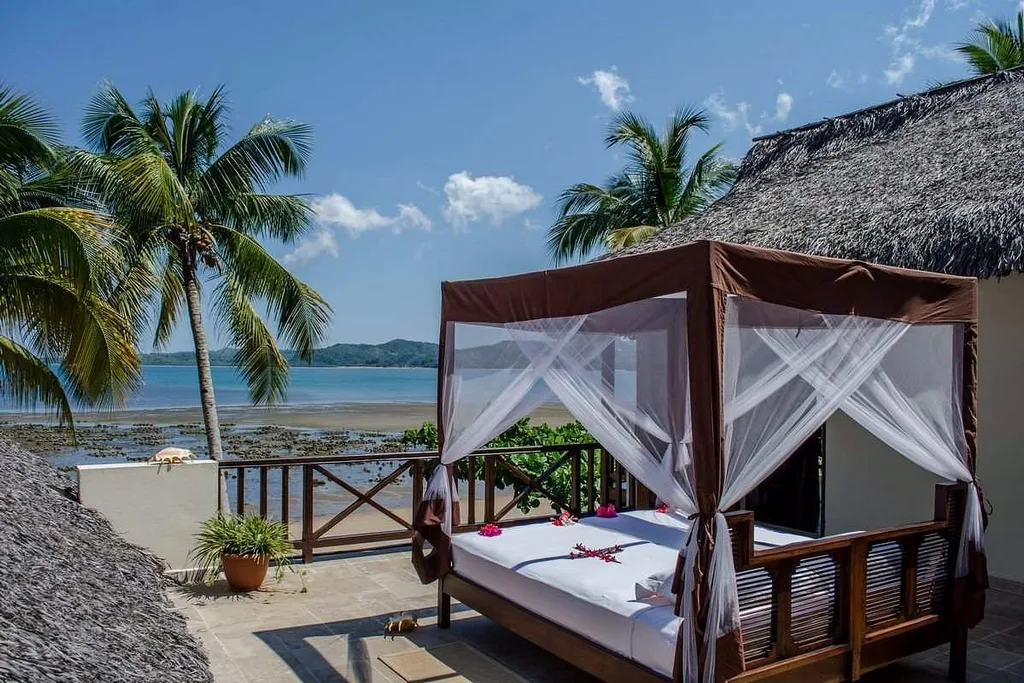 covered bed on deck overlooking ocean