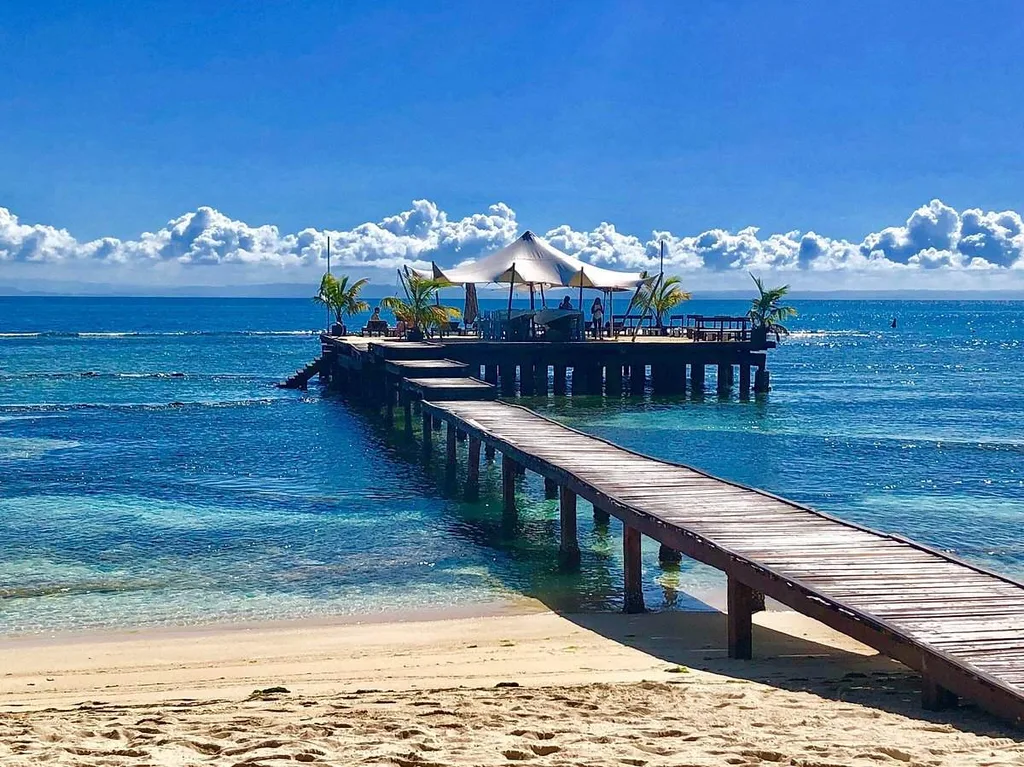 dock leading from beach to ocean