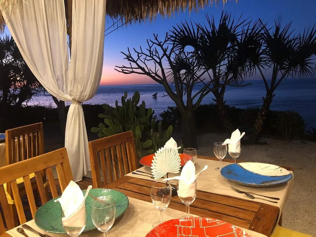 dinner table on the beach at sunset