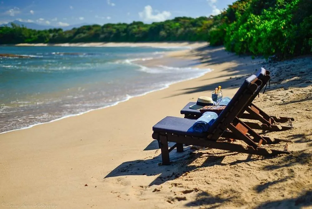 two lounge chairs on the beach