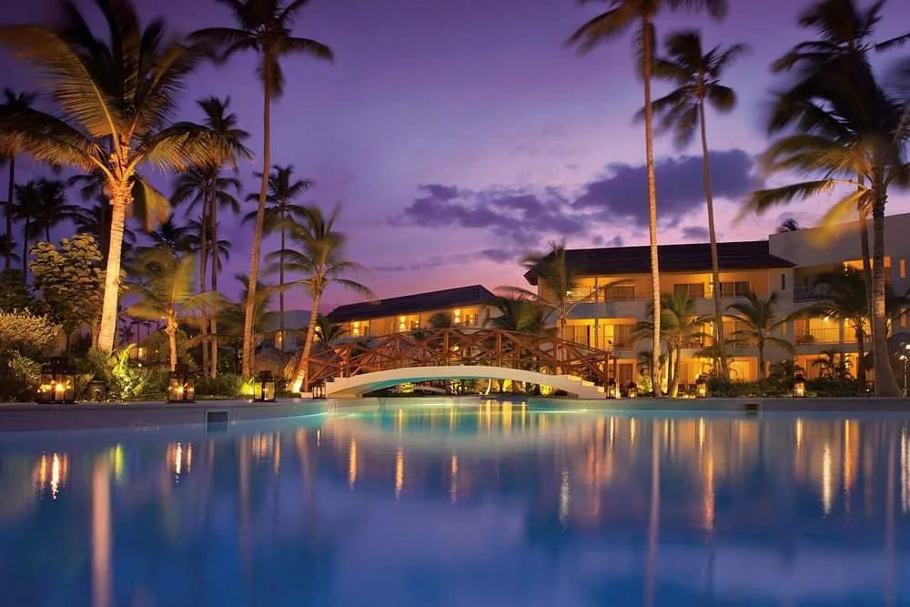 resort behind pool with purple sky