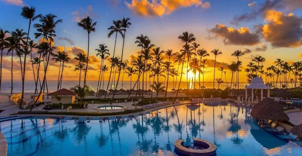 tropical resort pool at sunset