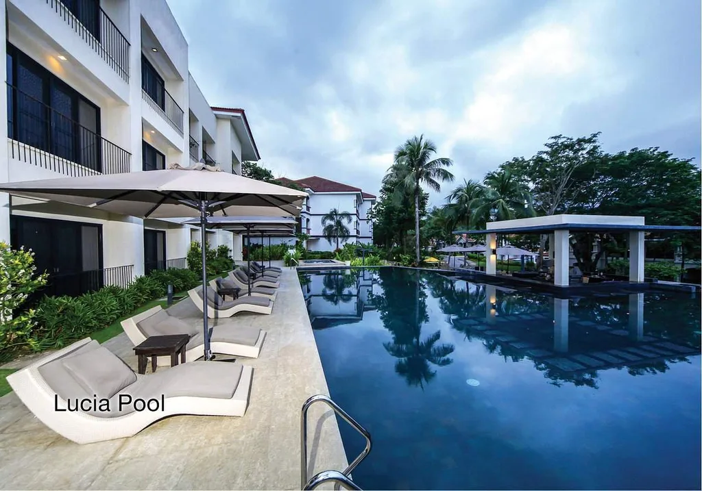 resort infinity pool surrounded by lounge chairs