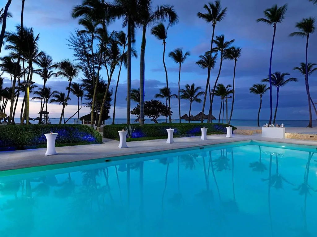 large resort pool surrounded by palm trees
