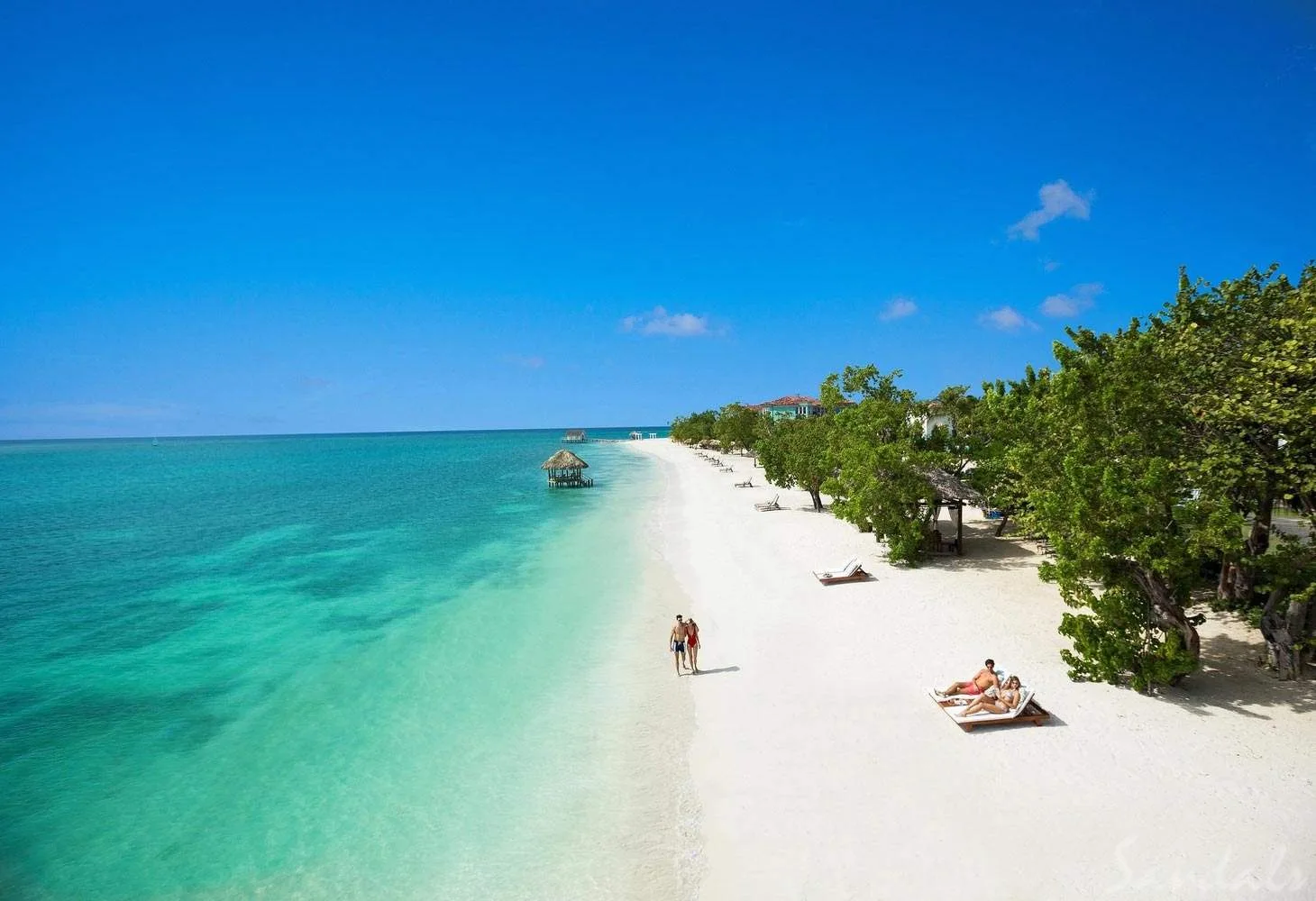 two people walking along the beach