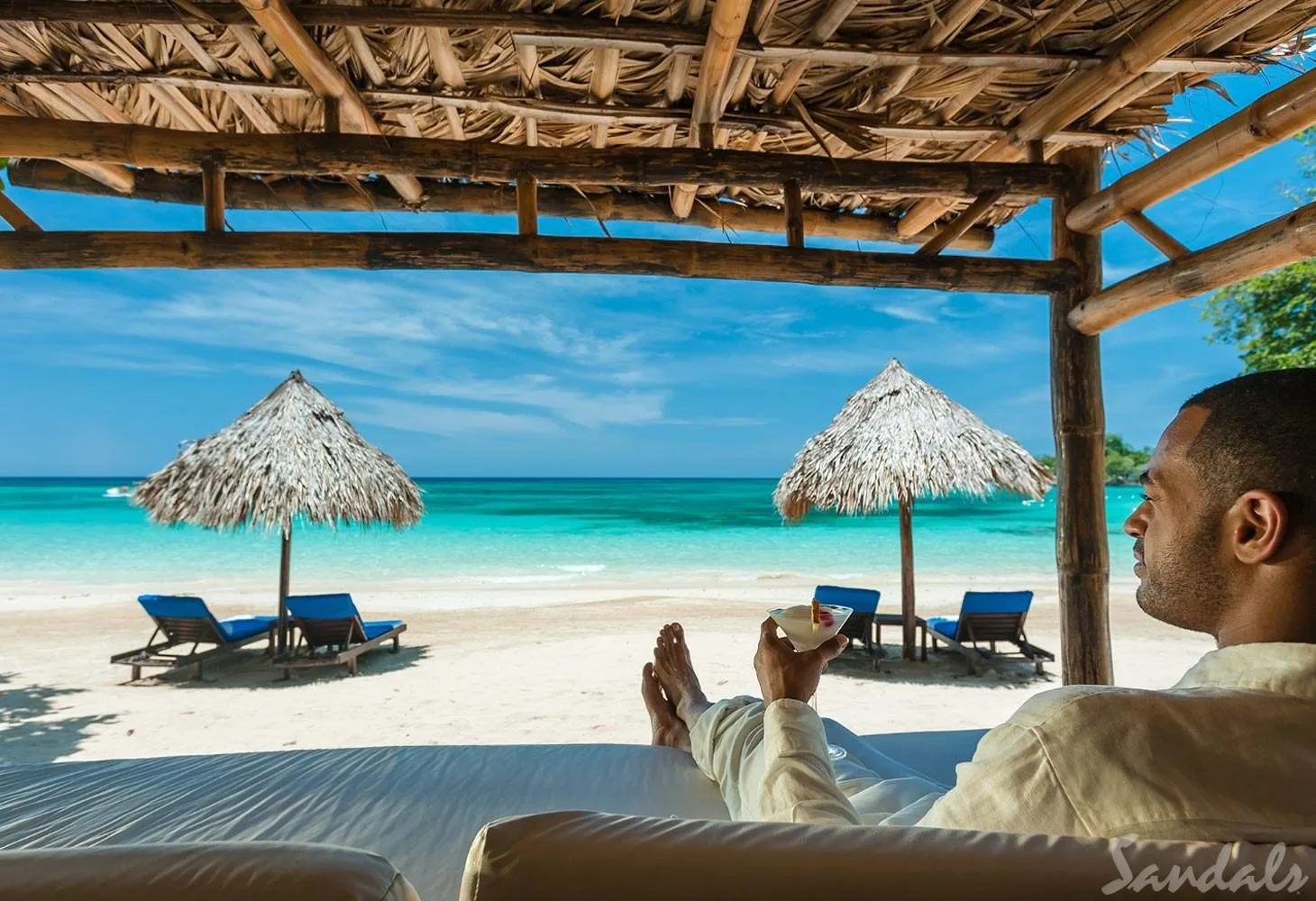 man under cabana on beach
