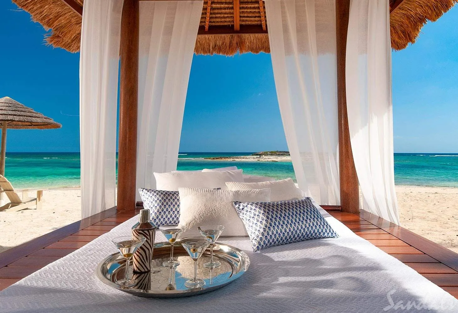 cabana on beach with wine glasses