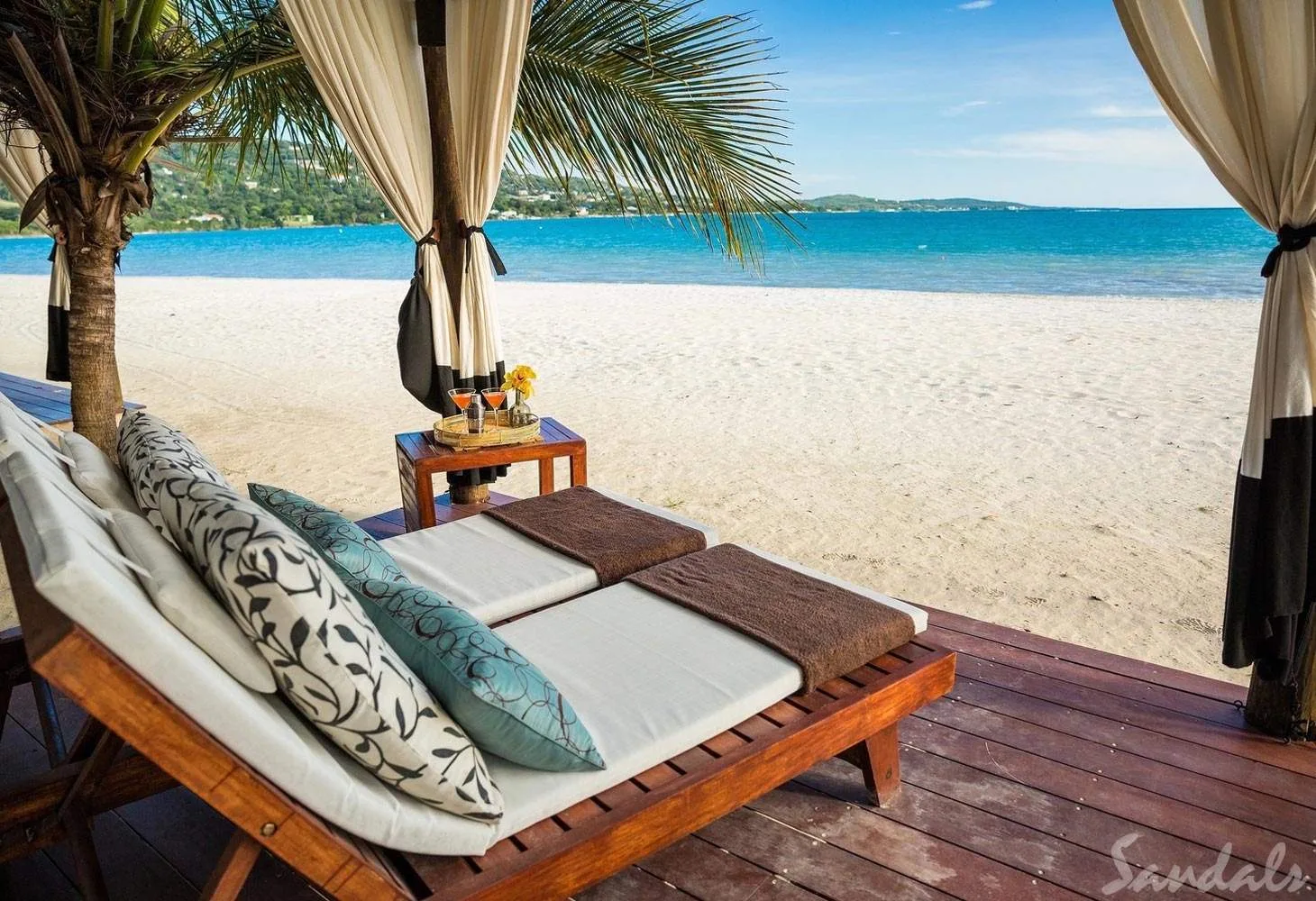 two lounge chairs under cabana